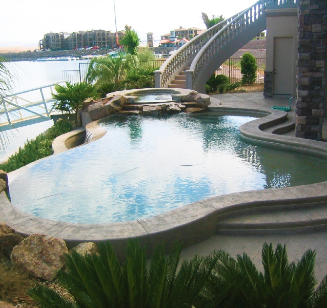 Luxury pool with spa and water feature.